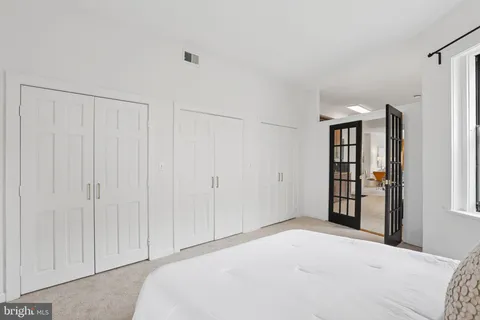 a bedroom with a large bed and a window