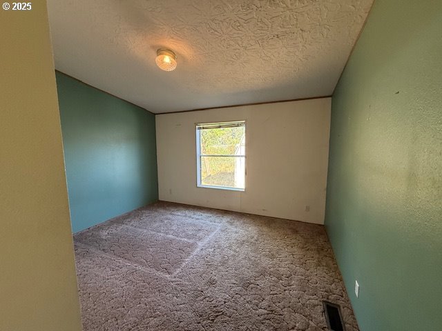 903 Cook Street Myrtle Creek, OR 97457 - Photo 14 of 20 an empty room with windows and yard
