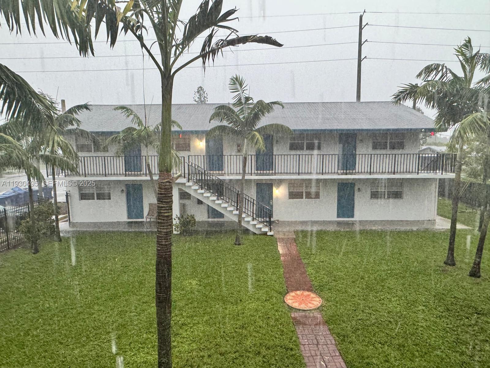 201 West Blue Heron Boulevard Riviera Beach, FL 33404 - Photo 12 of 12 a front view of a house with a garden and a yard