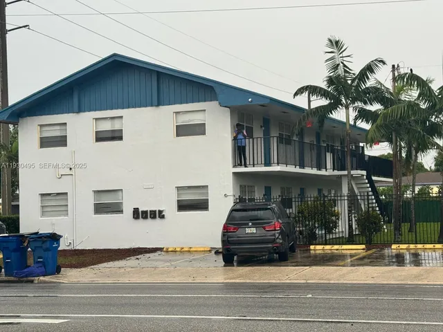 a view of a building with car parked