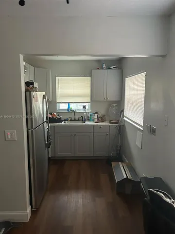 a kitchen with stainless steel appliances a refrigerator and a sink