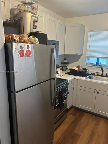 a white refrigerator freezer sitting inside of a kitchen