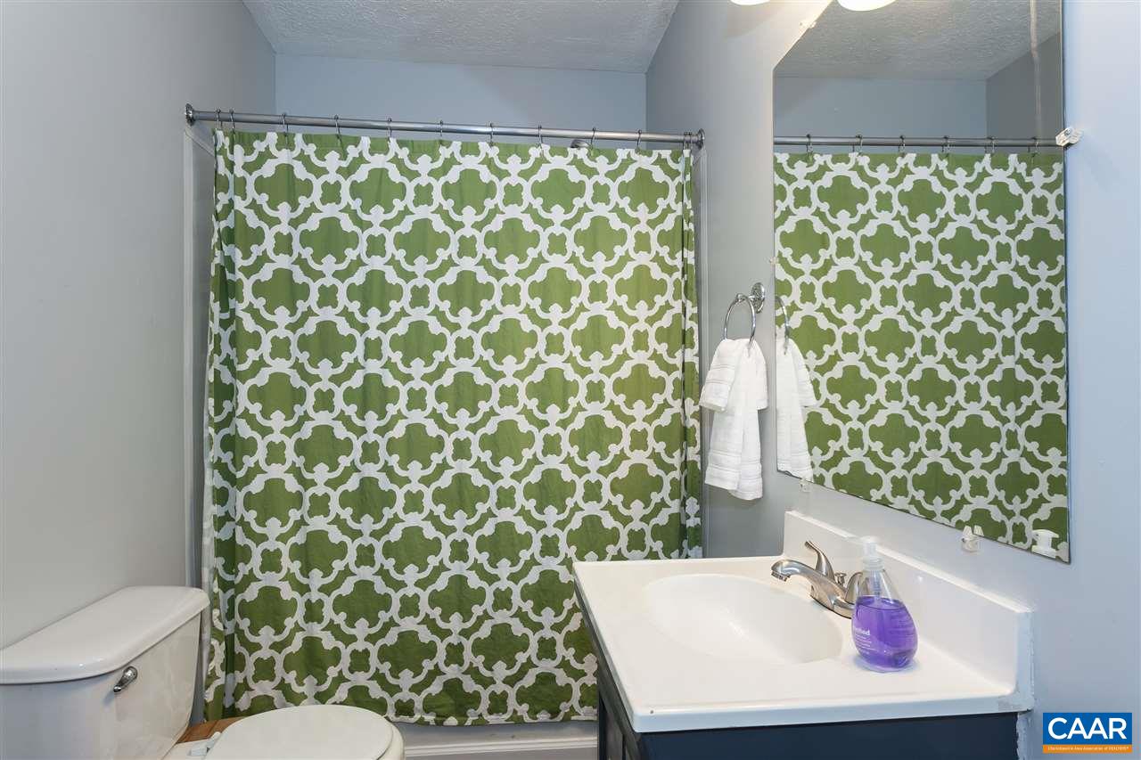 1 Dogleg Road Palmyra, VA 22963 - Photo 16 of 19 a bathroom with a toilet and shower curtain