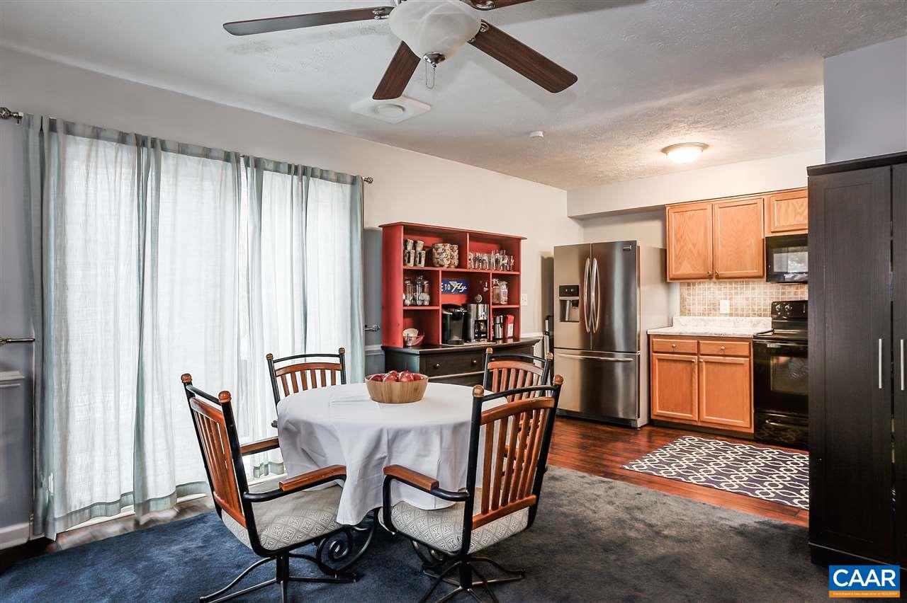 1 Dogleg Road Palmyra, VA 22963 - Photo 6 of 19 a kitchen with stainless steel appliances a dining table chairs and a refrigerator