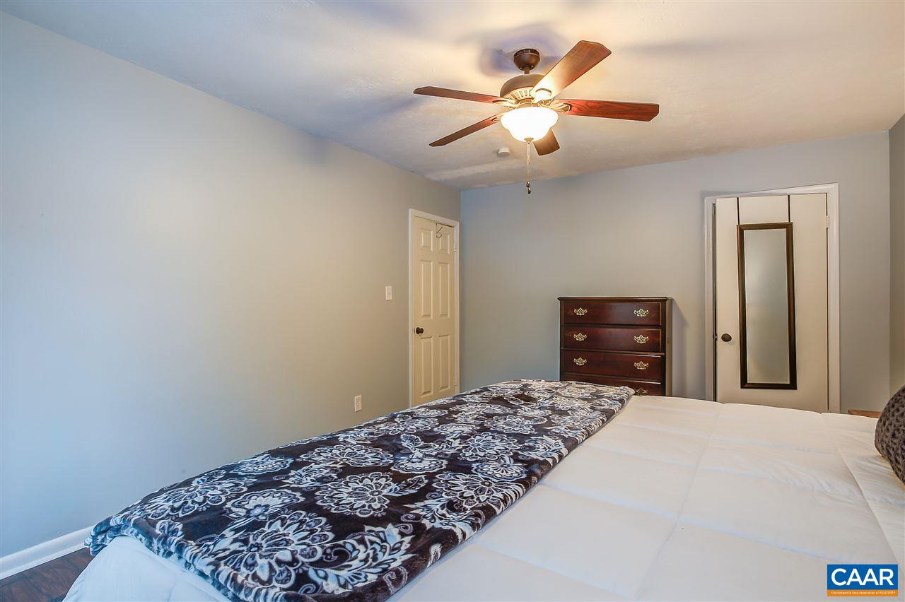 1 Dogleg Road Palmyra, VA 22963 - Photo 8 of 19 a bedroom with a large bed and a chandelier