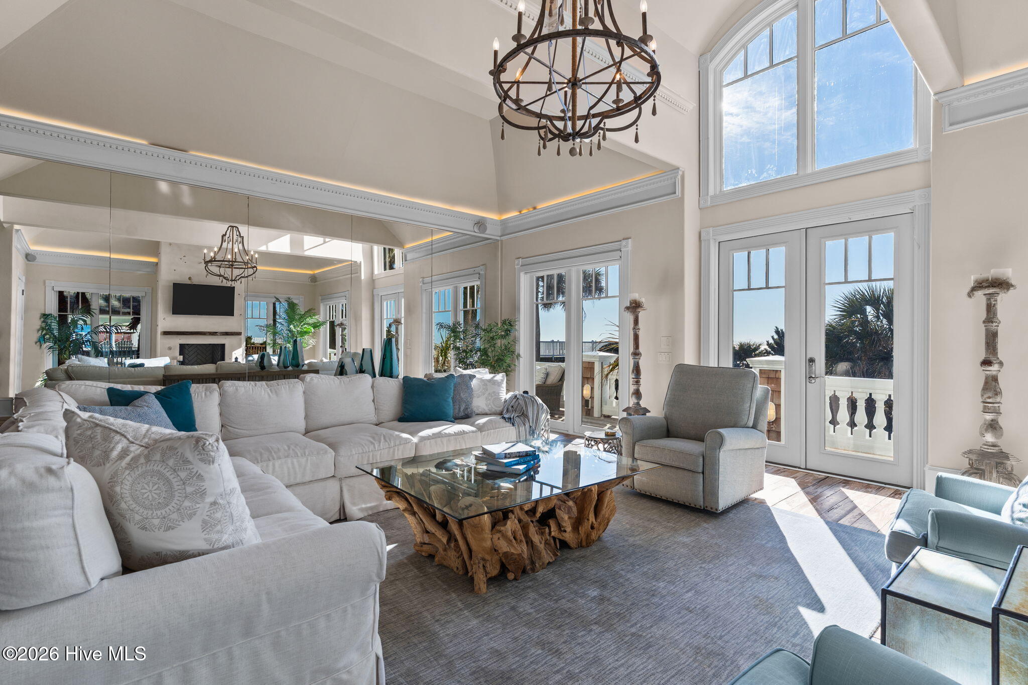 241 West First Street Ocean Isle Beach, NC 28469 - Photo 9 of 124 Living room features vaulted ceilings, floor to ceiling window and luxury moldings.