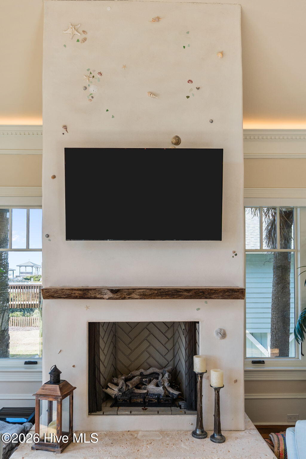 241 West First Street Ocean Isle Beach, NC 28469 - Photo 16 of 124 Living room fireplace with coastal chic surround.