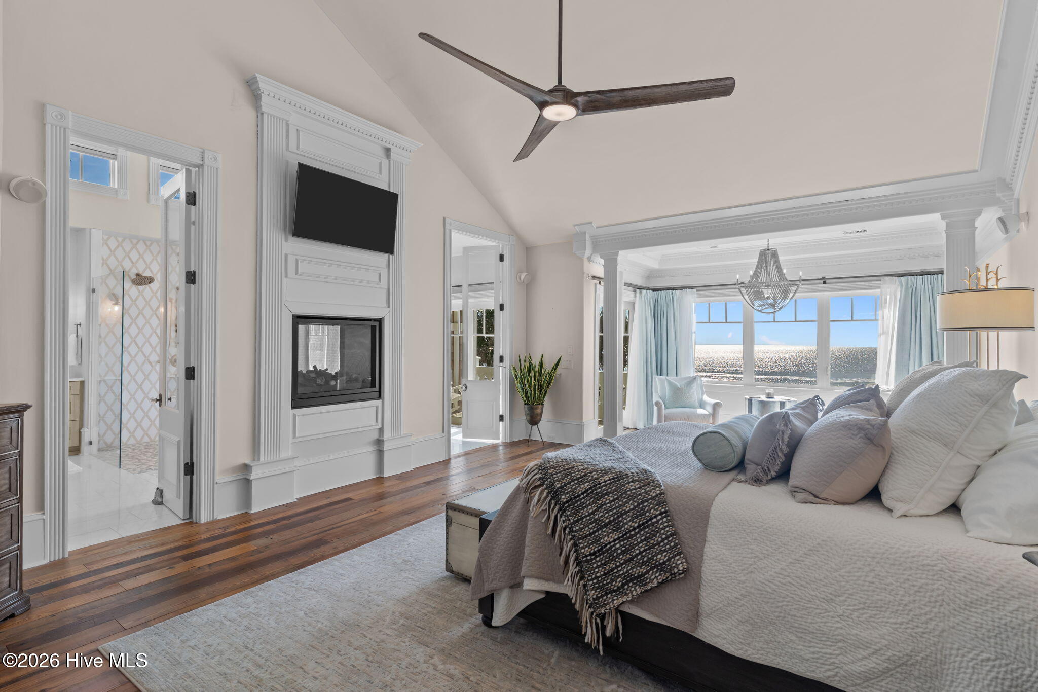 241 West First Street Ocean Isle Beach, NC 28469 - Photo 48 of 124 Large primary bedroom with hardwood flooring, custom crown moldings throughout.