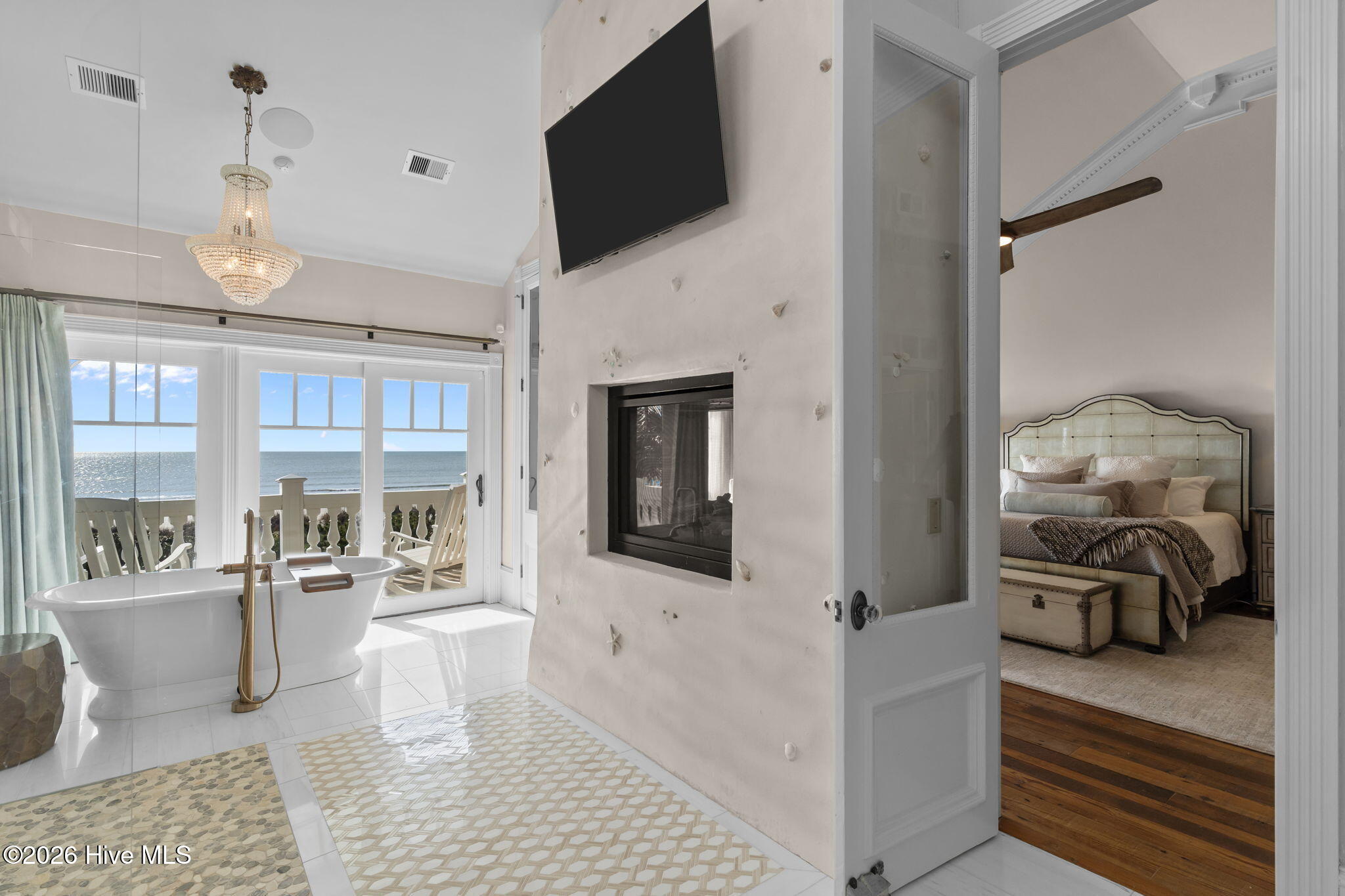 241 West First Street Ocean Isle Beach, NC 28469 - Photo 55 of 124 Two-way fireplace serves as stylish architectural feature.