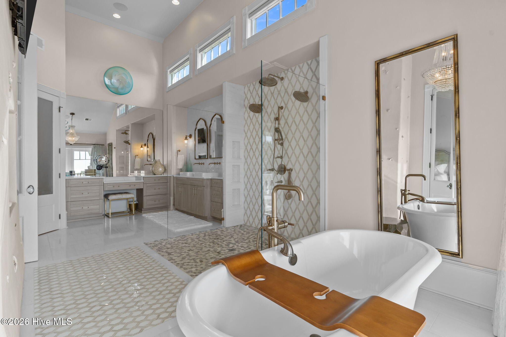 241 West First Street Ocean Isle Beach, NC 28469 - Photo 57 of 124 Large primary bathroom with high ceilings and windows.