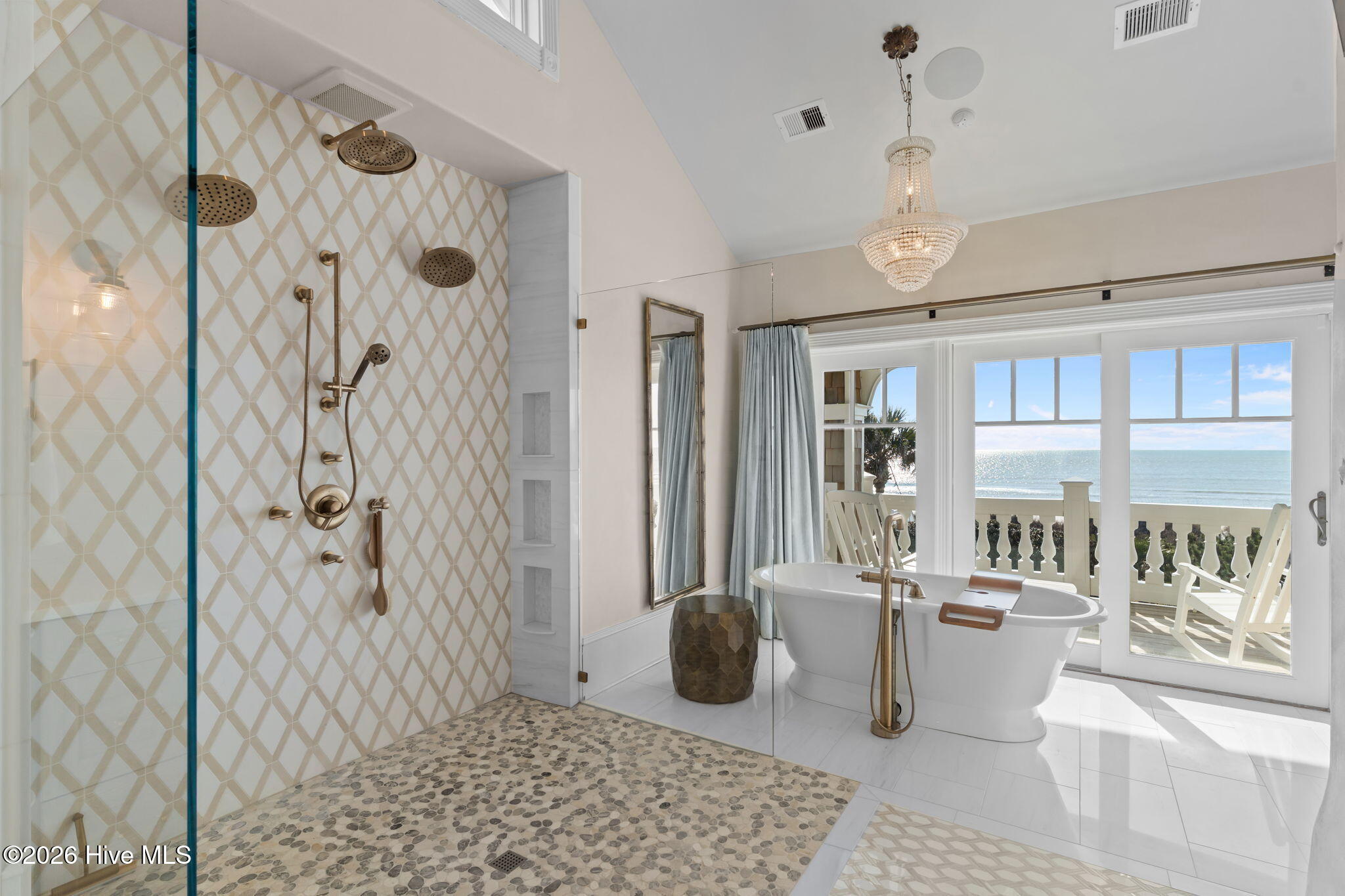 241 West First Street Ocean Isle Beach, NC 28469 - Photo 60 of 124 Zero entry shower with multiple shower heads. Tile shower with pebble shower floor. Open and airy feel with plenty of natural light.