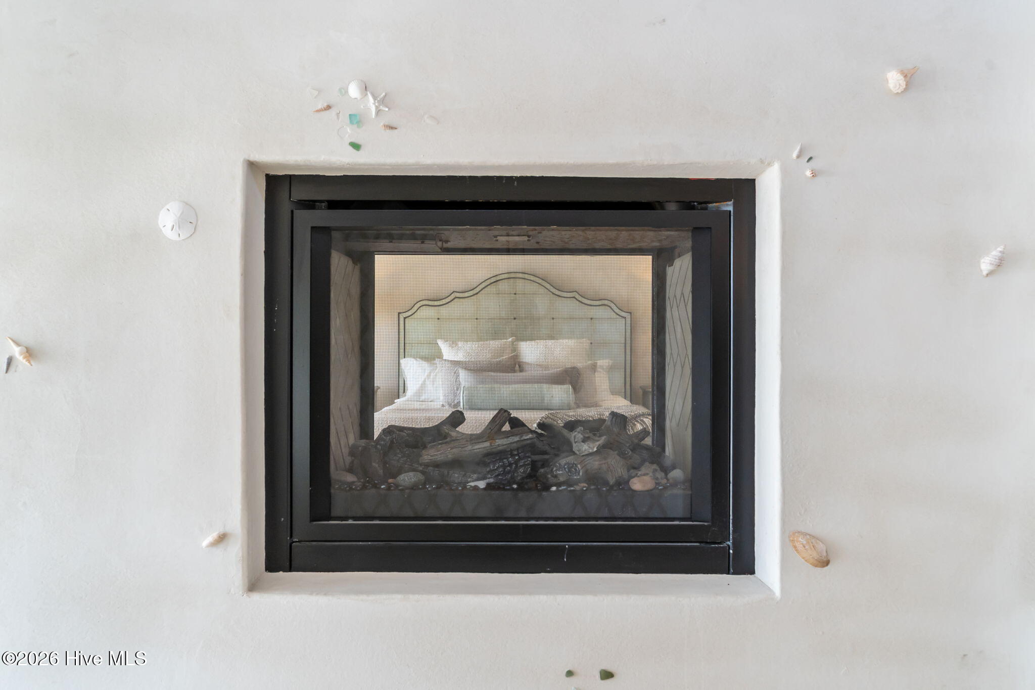241 West First Street Ocean Isle Beach, NC 28469 - Photo 68 of 124 Primary bedroom/bathroom double sided fireplace marries elegance and natural elements.
