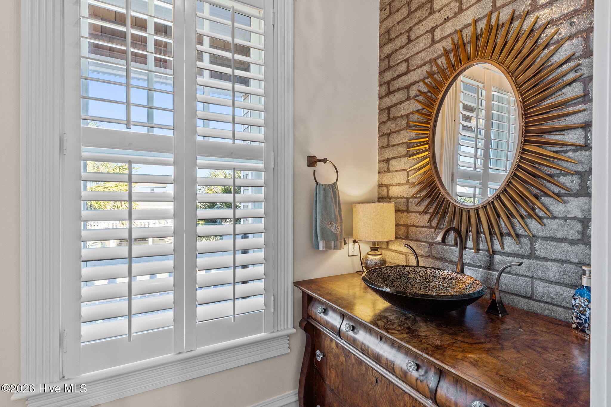 241 West First Street Ocean Isle Beach, NC 28469 - Photo 79 of 124 Half bath with antique cabinet and tile backsplash.
