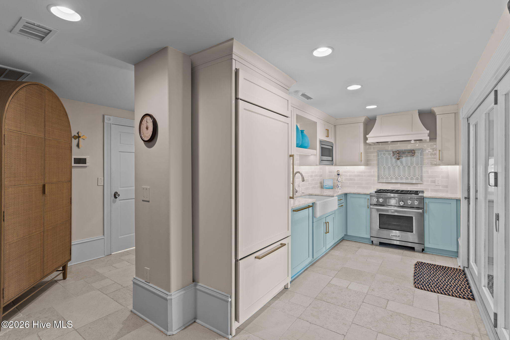 241 West First Street Ocean Isle Beach, NC 28469 - Photo 83 of 124 Ground floor chef's kitchen with Wolf range, quartz countertops, Sub-Zero refrigerator.