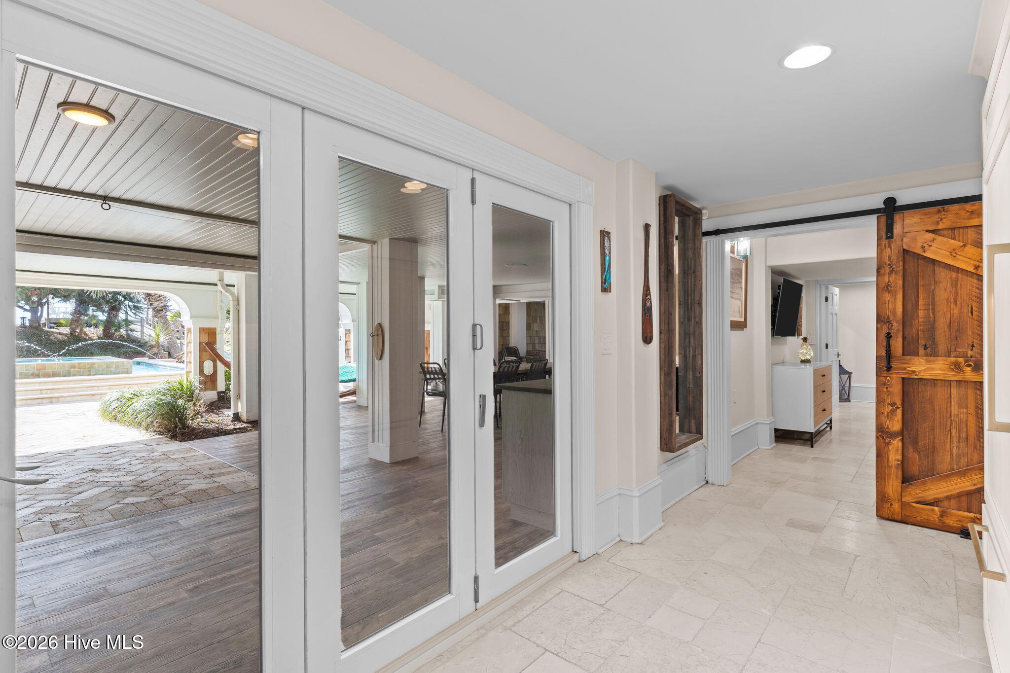 241 West First Street Ocean Isle Beach, NC 28469 - Photo 85 of 124 View from ground level chef's kitchen towards bedroom with sliding door. Easy to close off bedroom when entertaining with the ground floor kitchen.
