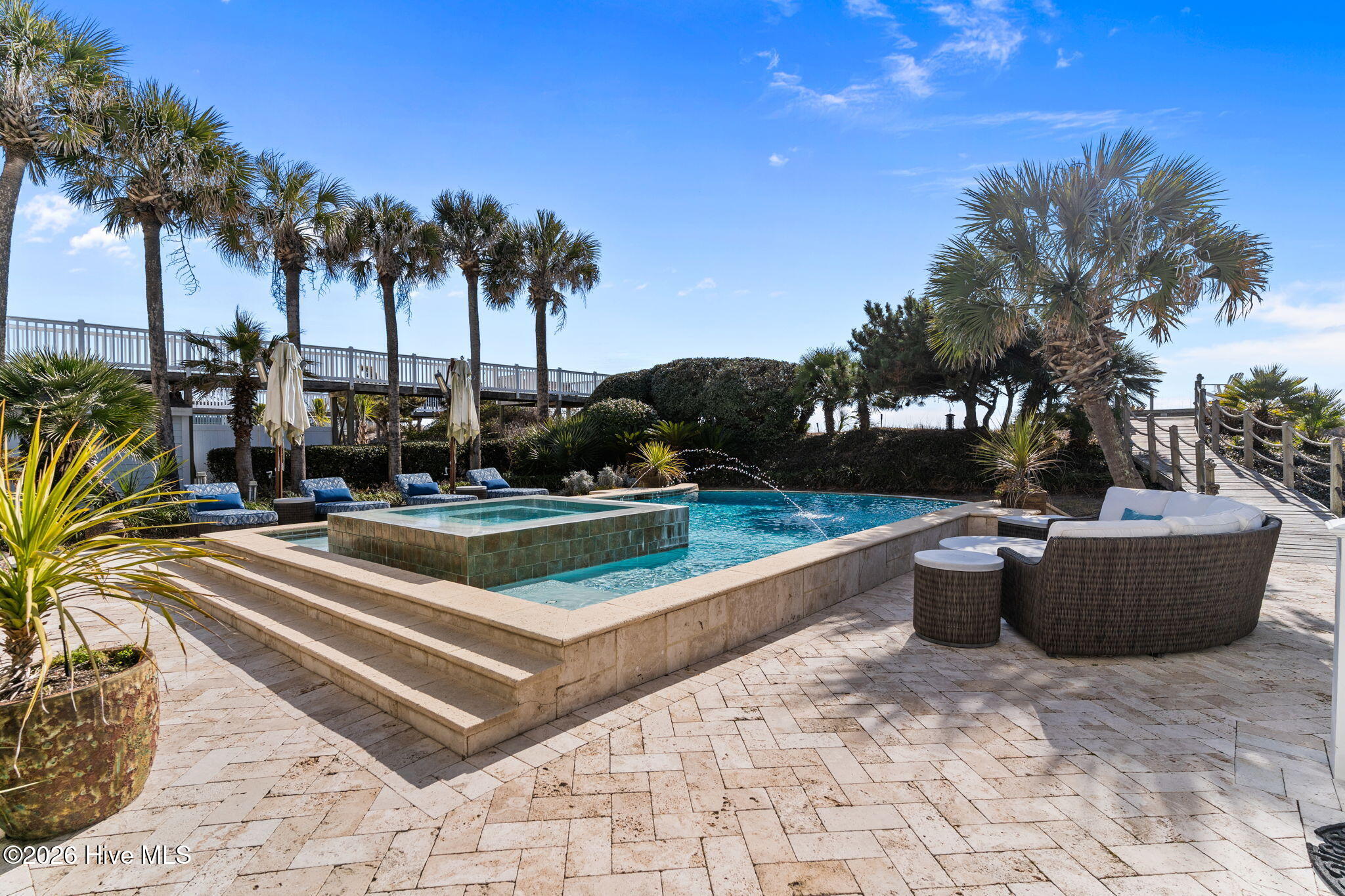 241 West First Street Ocean Isle Beach, NC 28469 - Photo 96 of 124 Resort inspired pool with hot tub. Paver lined backyard patio. Lush palms and loads of privacy.