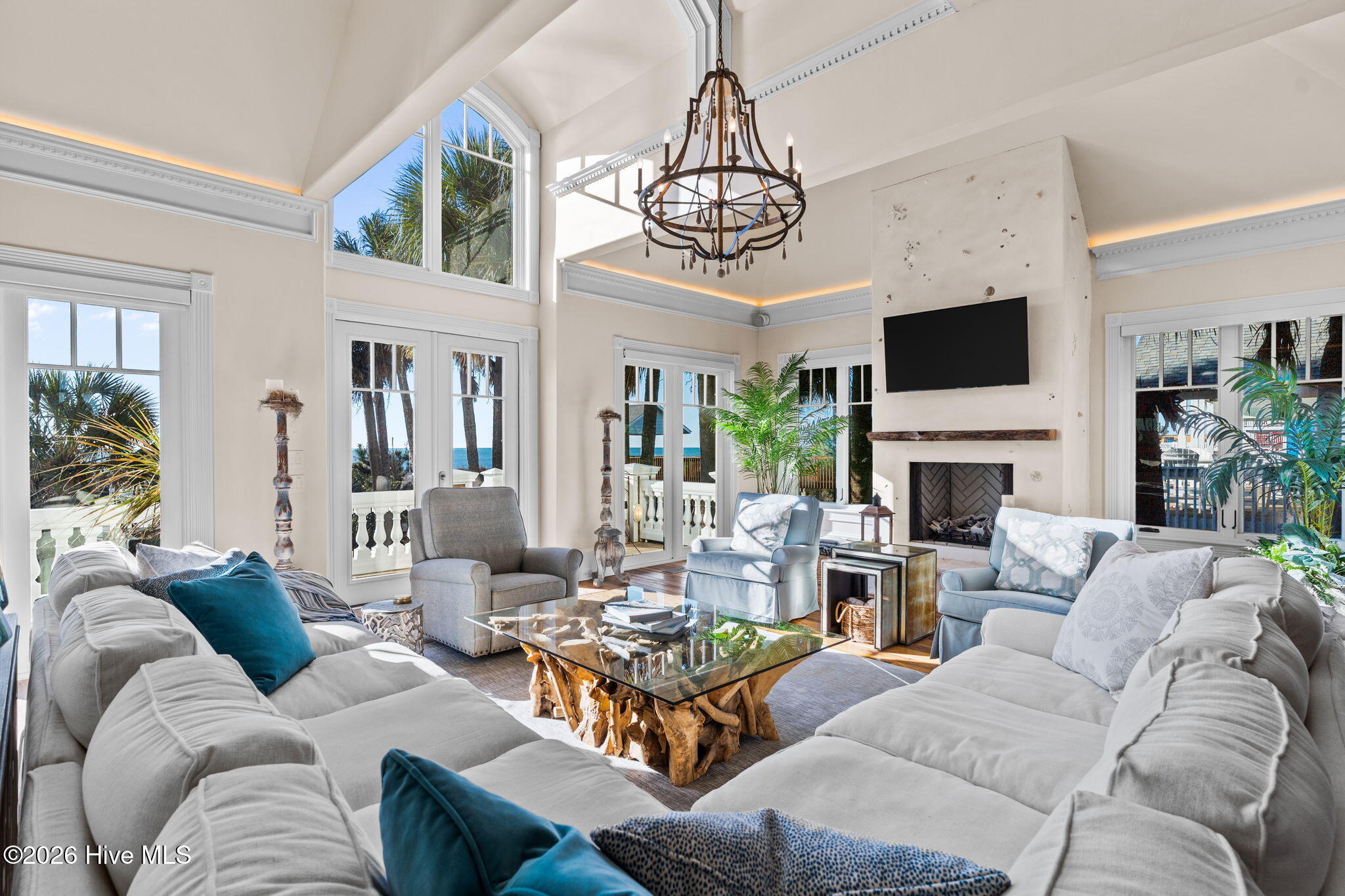 241 West First Street Ocean Isle Beach, NC 28469 - Photo 6 of 124 Fireplace with custom shell inlay surround and rustic wood mantle.