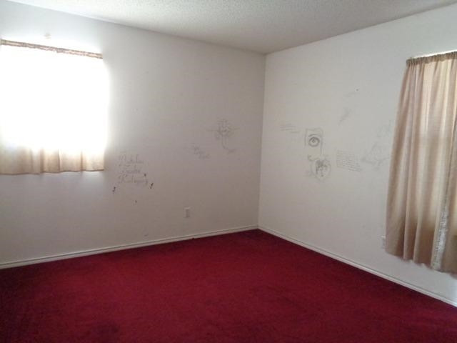 1500 5th Street Ralls, TX 79357 - Photo 8 of 10 an empty room with a window
