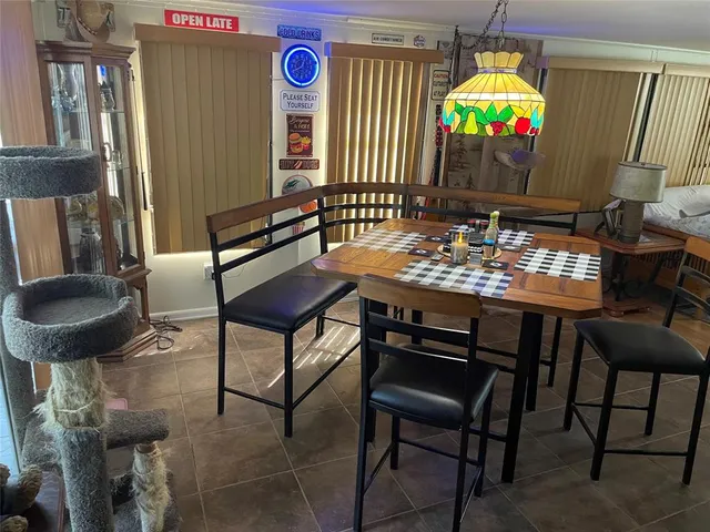 a view of a dining room with furniture and a chandelier