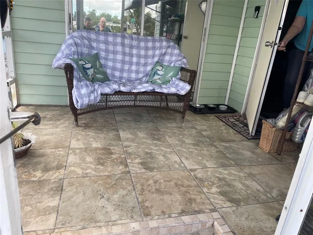 a backyard of a house with chairs and table