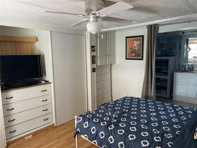 a bedroom with a bed and a television