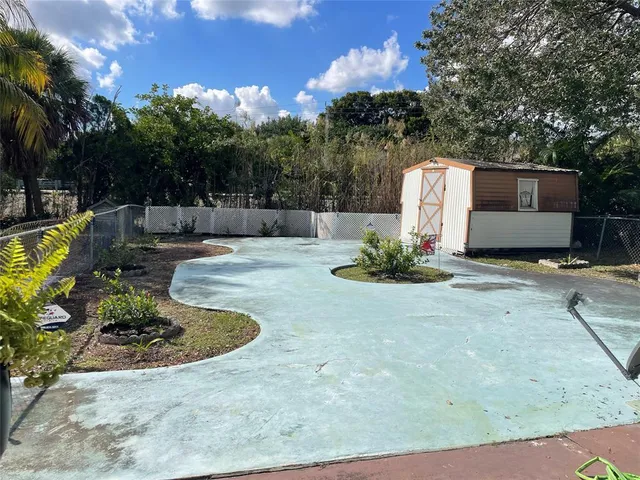 a view of a wooden house with a yard