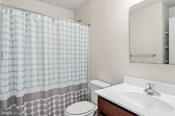 a bathroom with a sink toilet and mirror