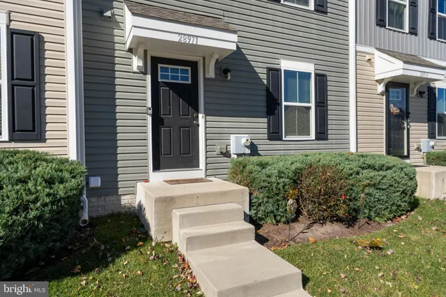 a view of a house with potted plants