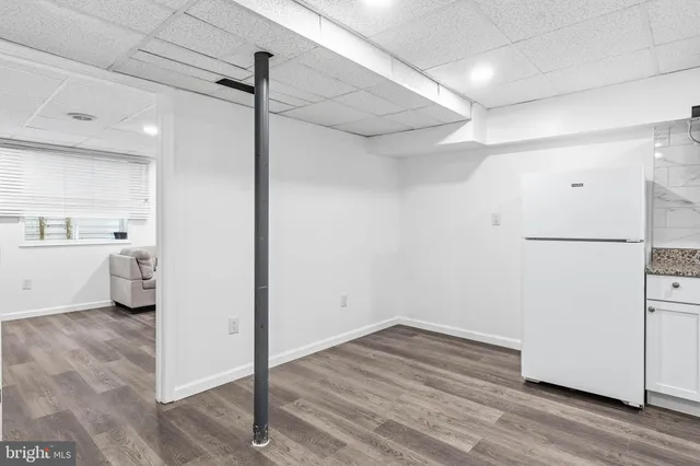 a kitchen with a sink cabinets and wooden floor