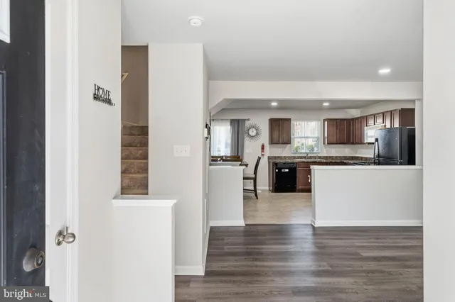 a large white kitchen with a refrigerator and a sink