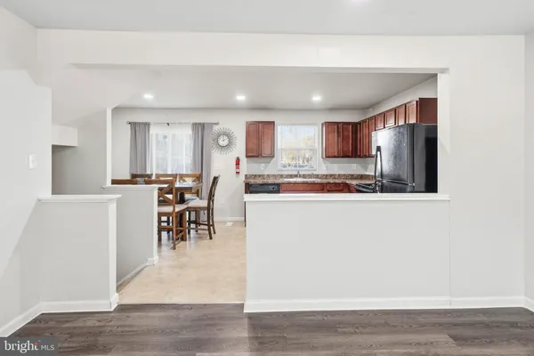 a kitchen with stainless steel appliances granite countertop a refrigerator a stove top oven a sink and dishwasher