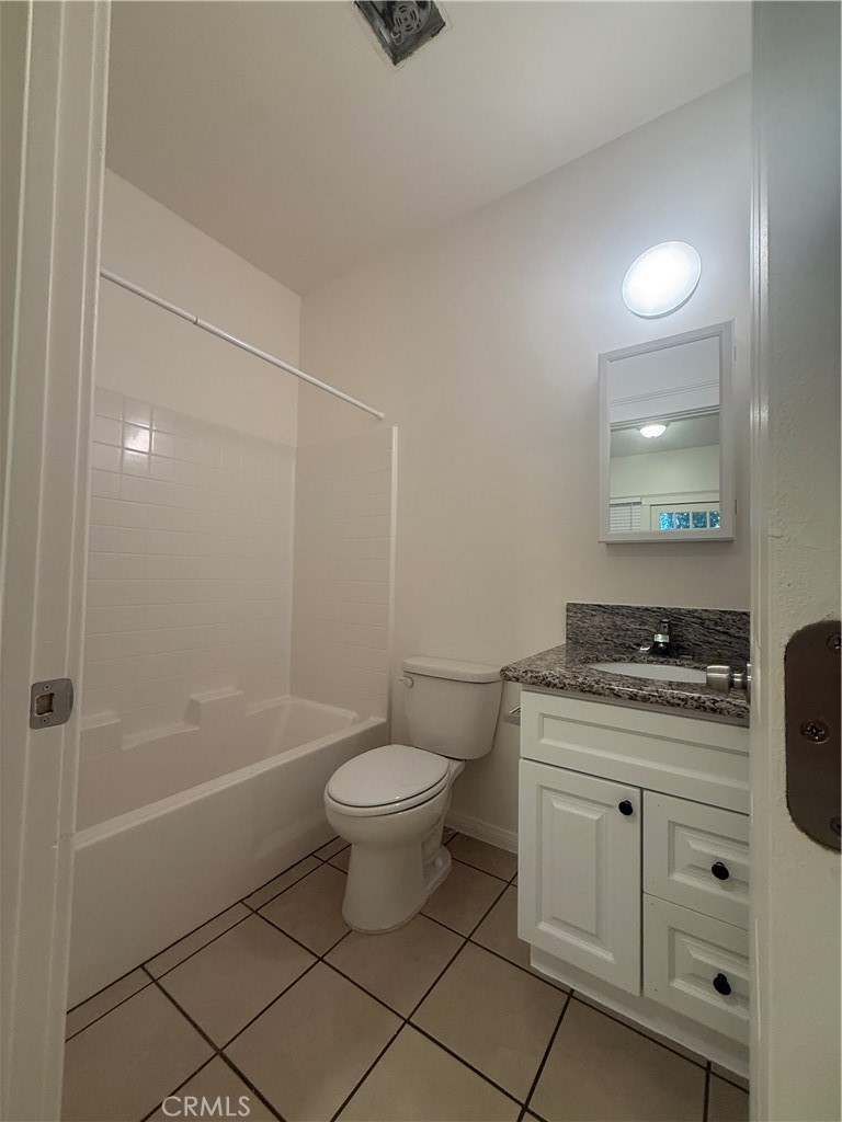 718 Chestnut Avenue, Unit 4 Long Beach, CA 90813 - Photo 5 of 11 a bathroom with a granite countertop sink a toilet and shower