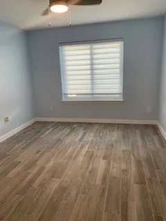 wooden floor in a room next to a window