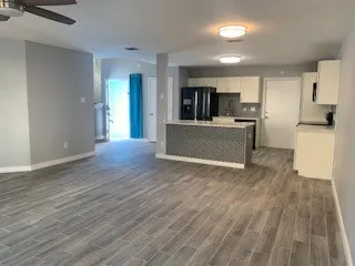 a view of kitchen with cabinets microwave and stove
