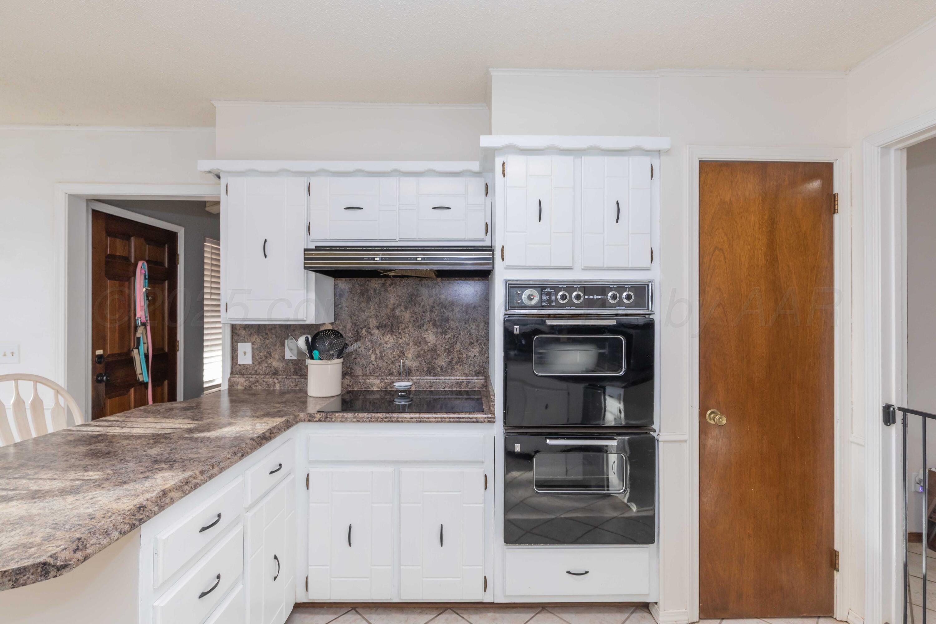 5301 Leigh Avenue Amarillo, TX 79110 - Photo 12 of 35 a kitchen with granite countertop a stove and a refrigerator