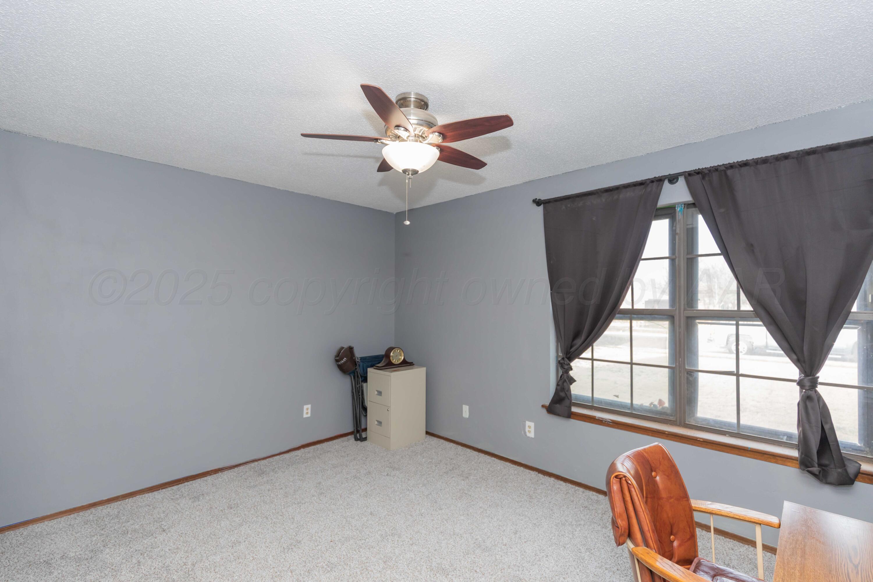 5301 Leigh Avenue Amarillo, TX 79110 - Photo 16 of 35 an empty room with windows and fan