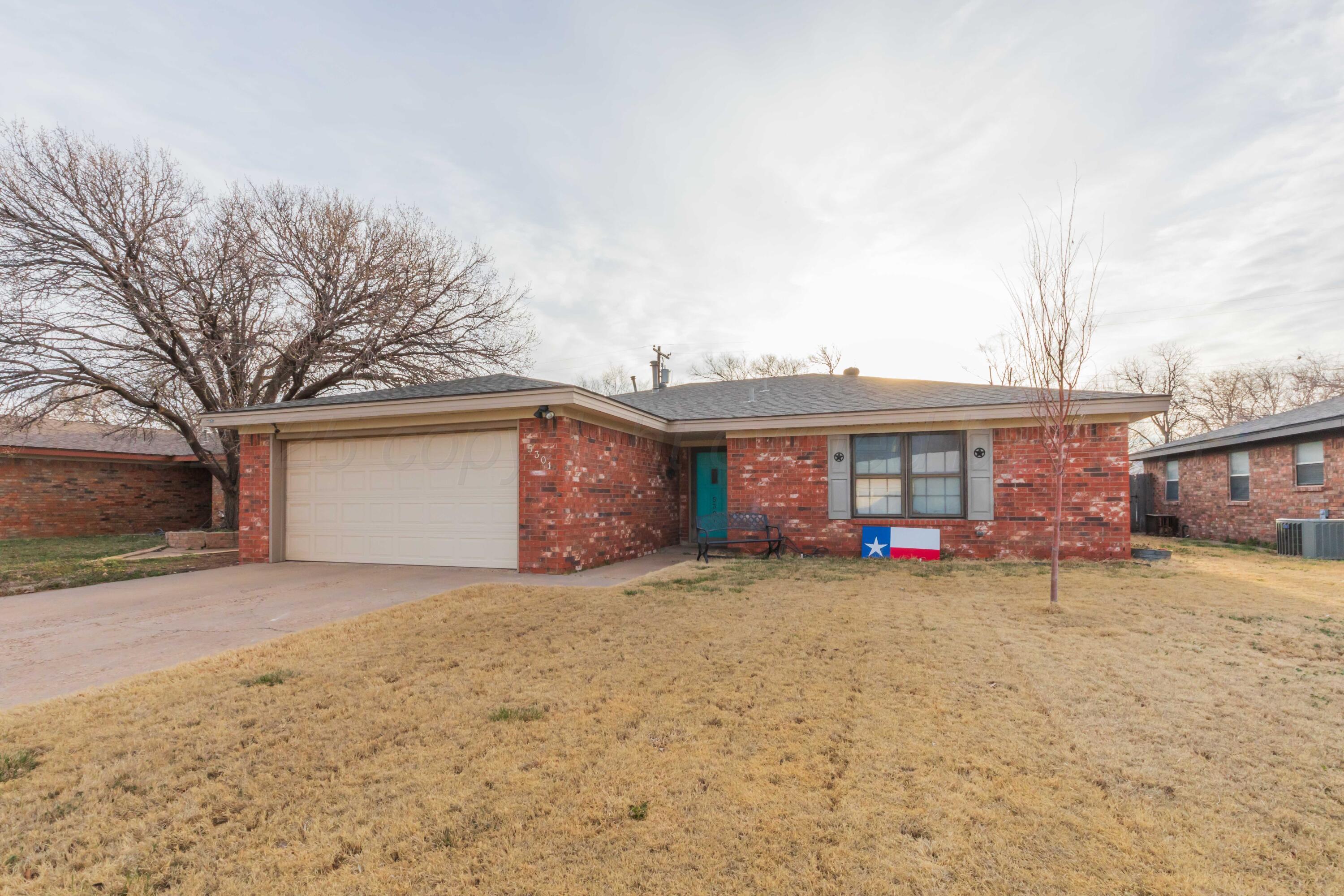 5301 Leigh Avenue Amarillo, TX 79110 - Photo 2 of 35 a view of a house with a yard and garage