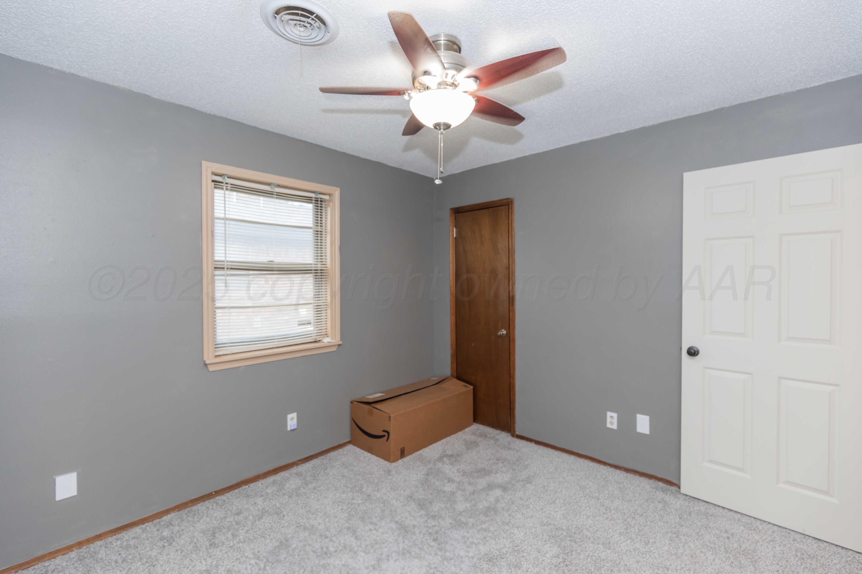 5301 Leigh Avenue Amarillo, TX 79110 - Photo 22 of 35 an empty room with windows and fan