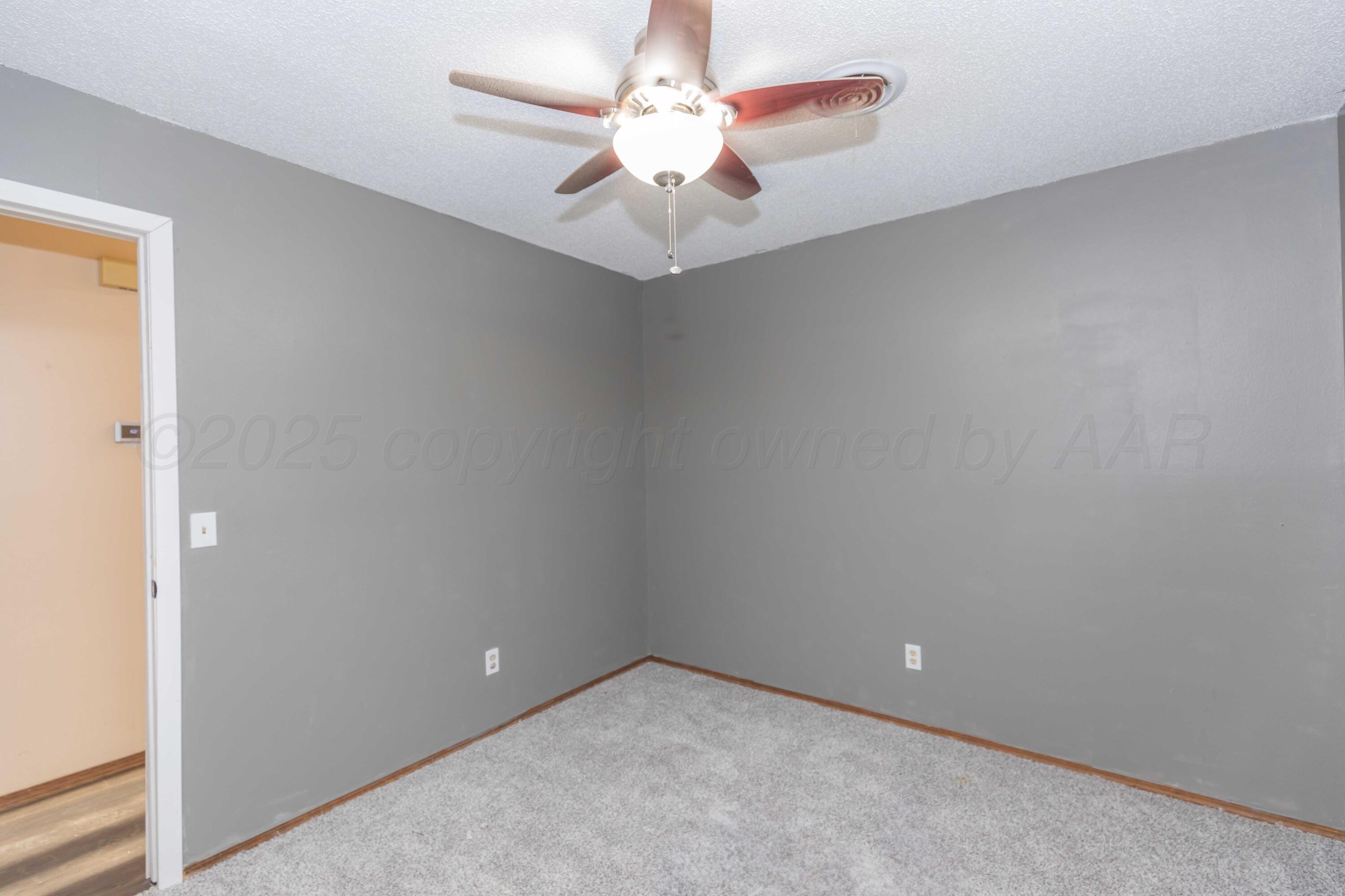 5301 Leigh Avenue Amarillo, TX 79110 - Photo 23 of 35 an empty room with a chandelier fan and closet