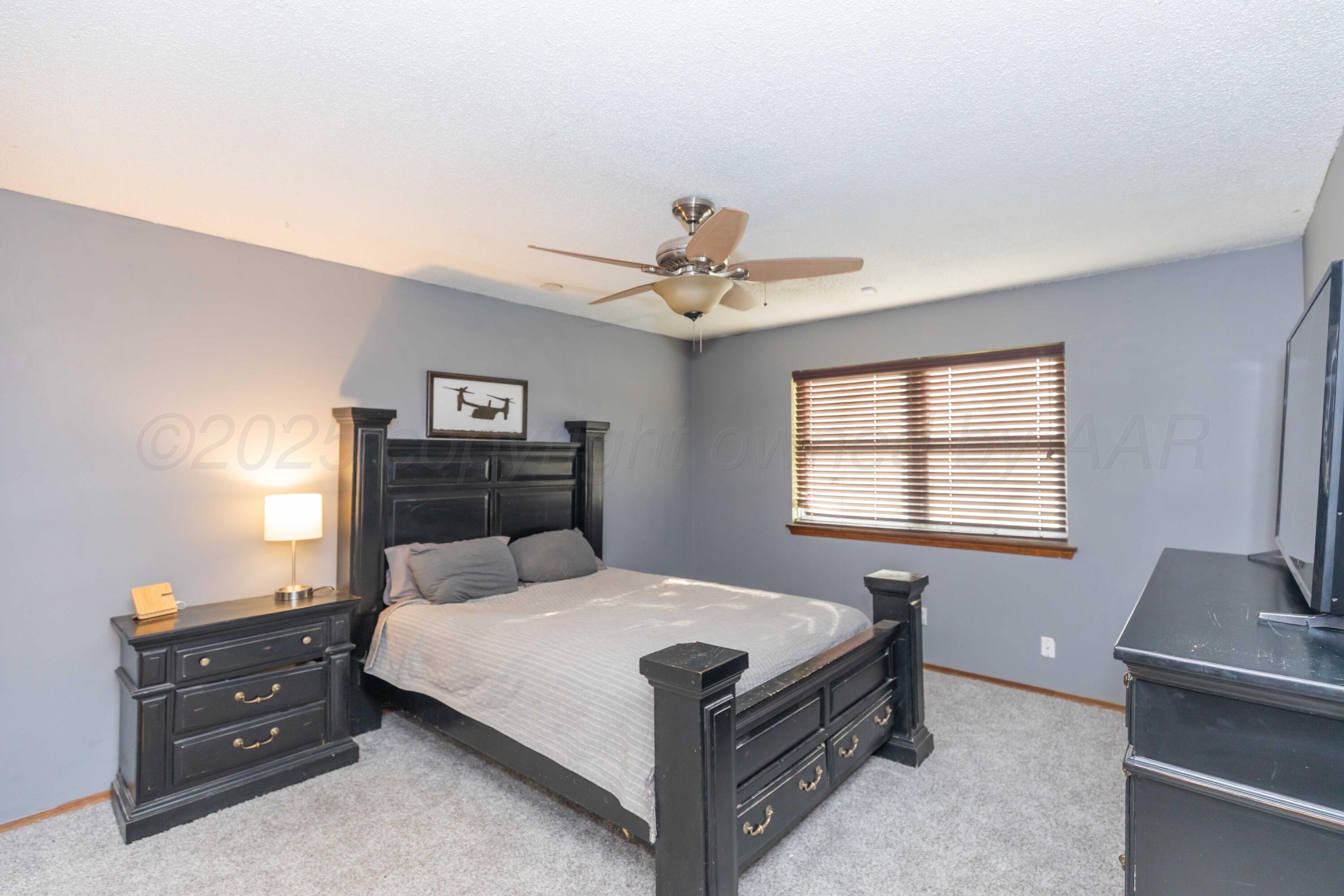 5301 Leigh Avenue Amarillo, TX 79110 - Photo 25 of 35 a bed room with a bed and a window