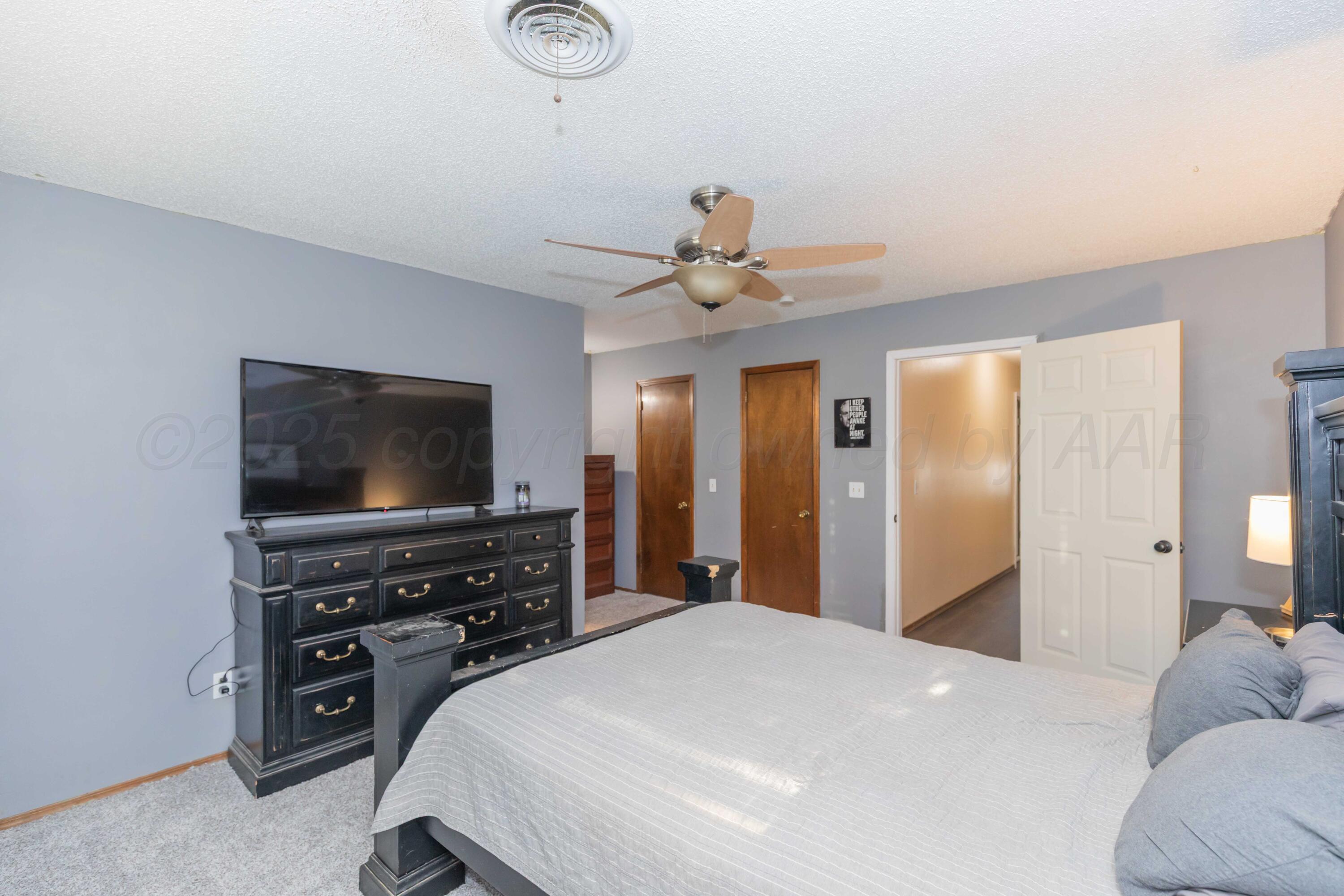 5301 Leigh Avenue Amarillo, TX 79110 - Photo 27 of 35 a bedroom with a bed and a flat screen tv