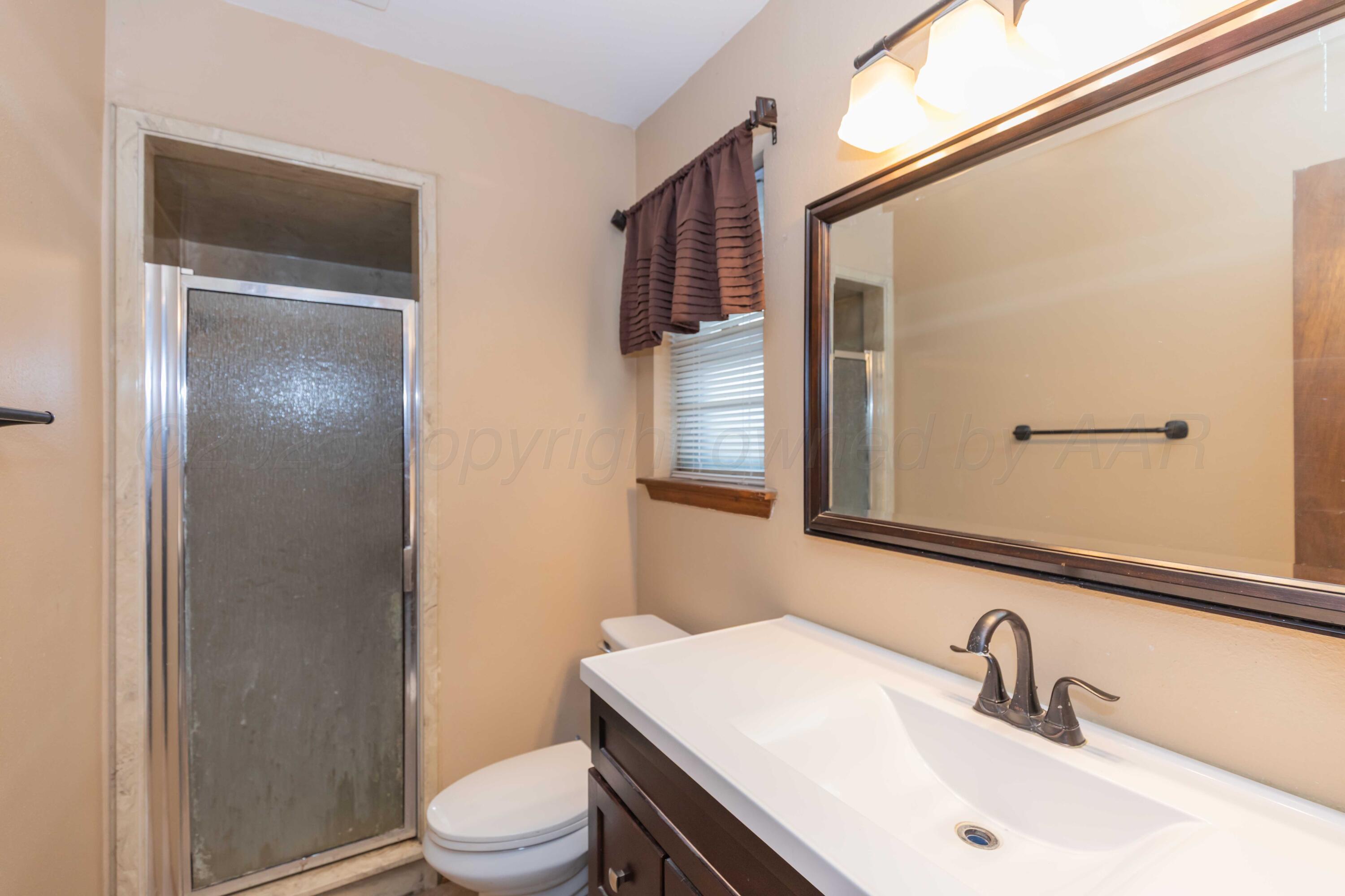 5301 Leigh Avenue Amarillo, TX 79110 - Photo 28 of 35 a bathroom with a sink a toilet and shower