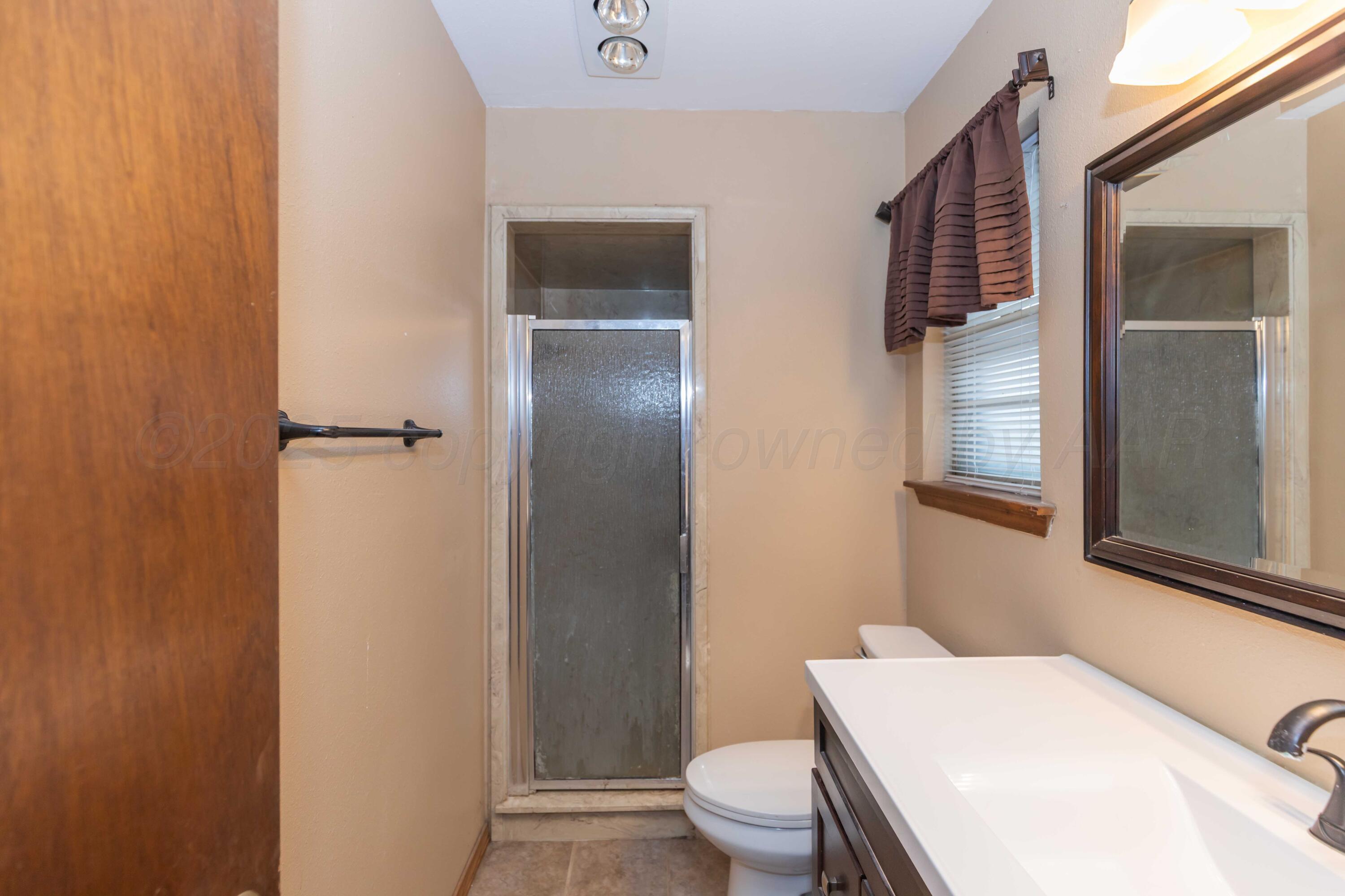 5301 Leigh Avenue Amarillo, TX 79110 - Photo 29 of 35 a white toilet sitting next to a bathroom sink