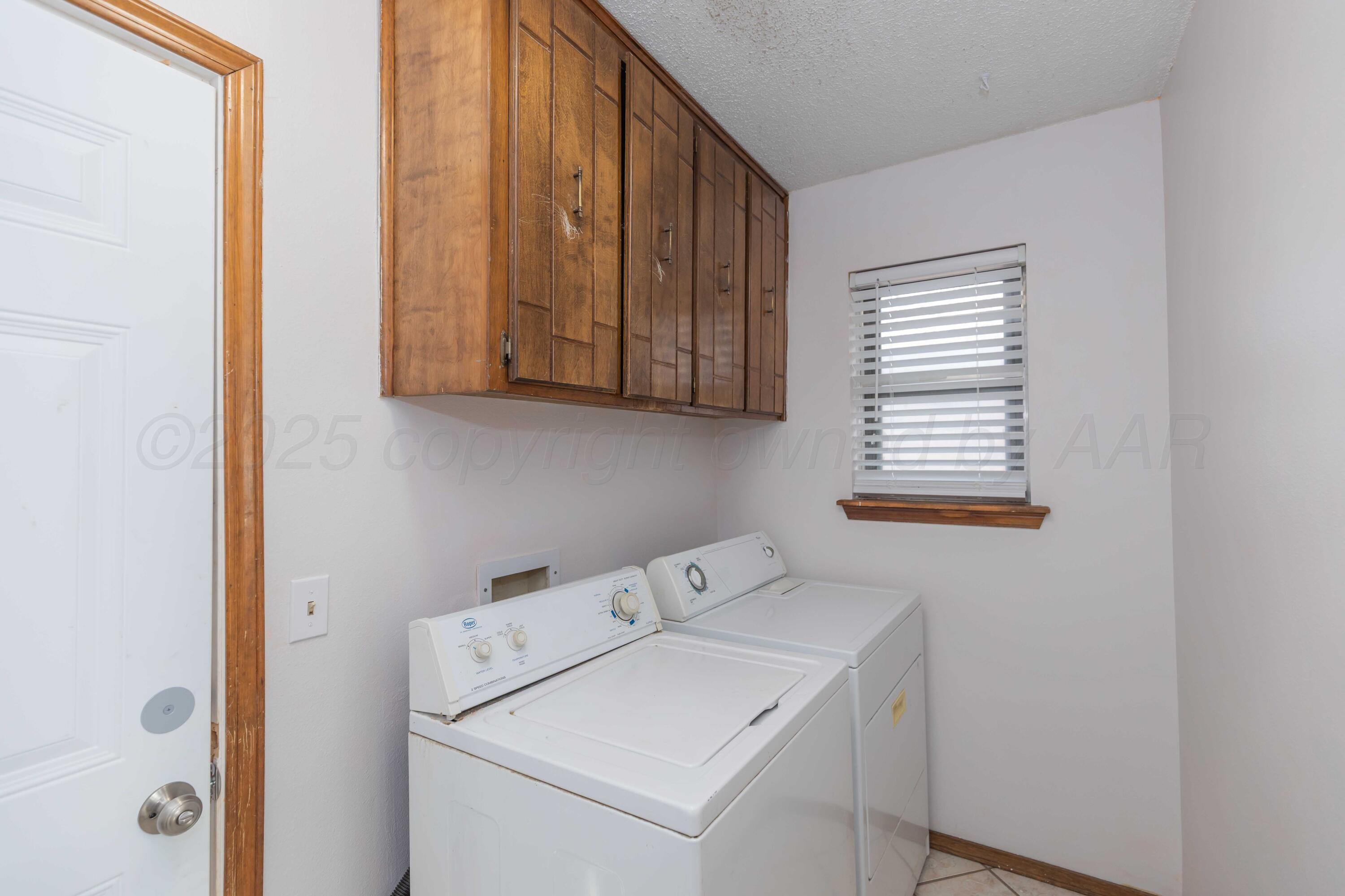 5301 Leigh Avenue Amarillo, TX 79110 - Photo 31 of 35 a utility room with dryer and washer