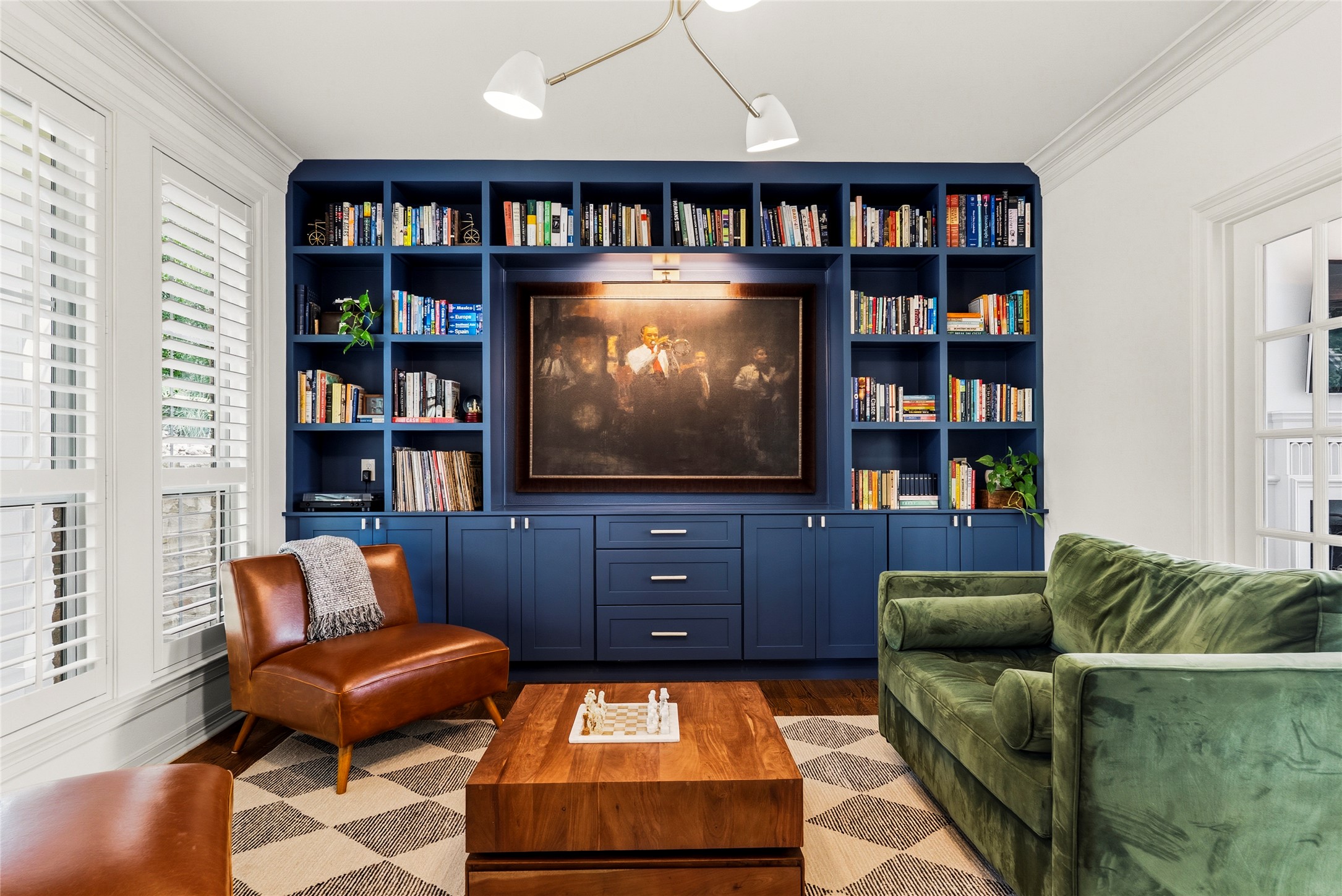 3107 Lookout Lane Austin, TX 78746 - Photo 3 of 39 Custom built-in shelving with an integrated media niche anchors this inviting living space.