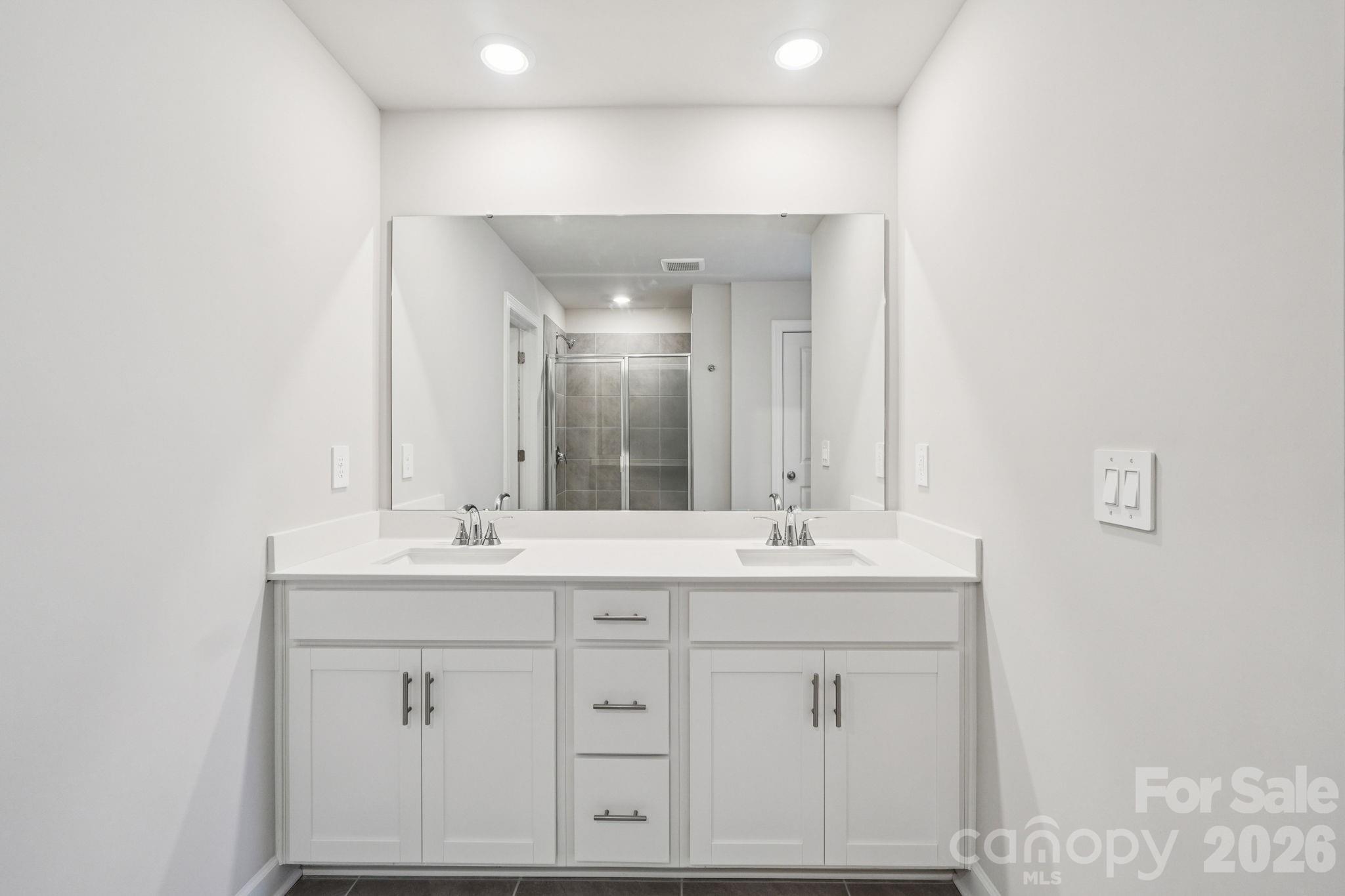 2452 Chartwell Street Stanley, NC 28164 - Photo 14 of 15 a bathroom with a sink and a mirror