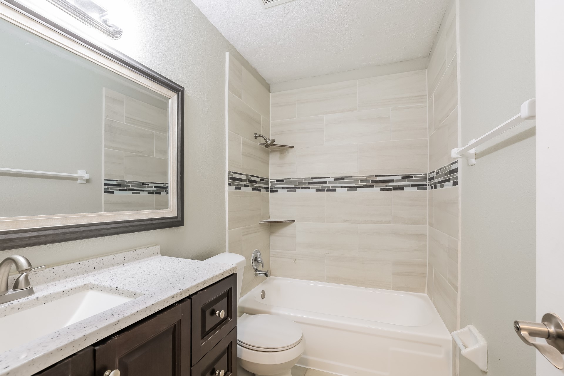 22826 Provincial Boulevard Katy, TX 77450 - Photo 17 of 18 a bathroom with a granite countertop sink toilet and shower