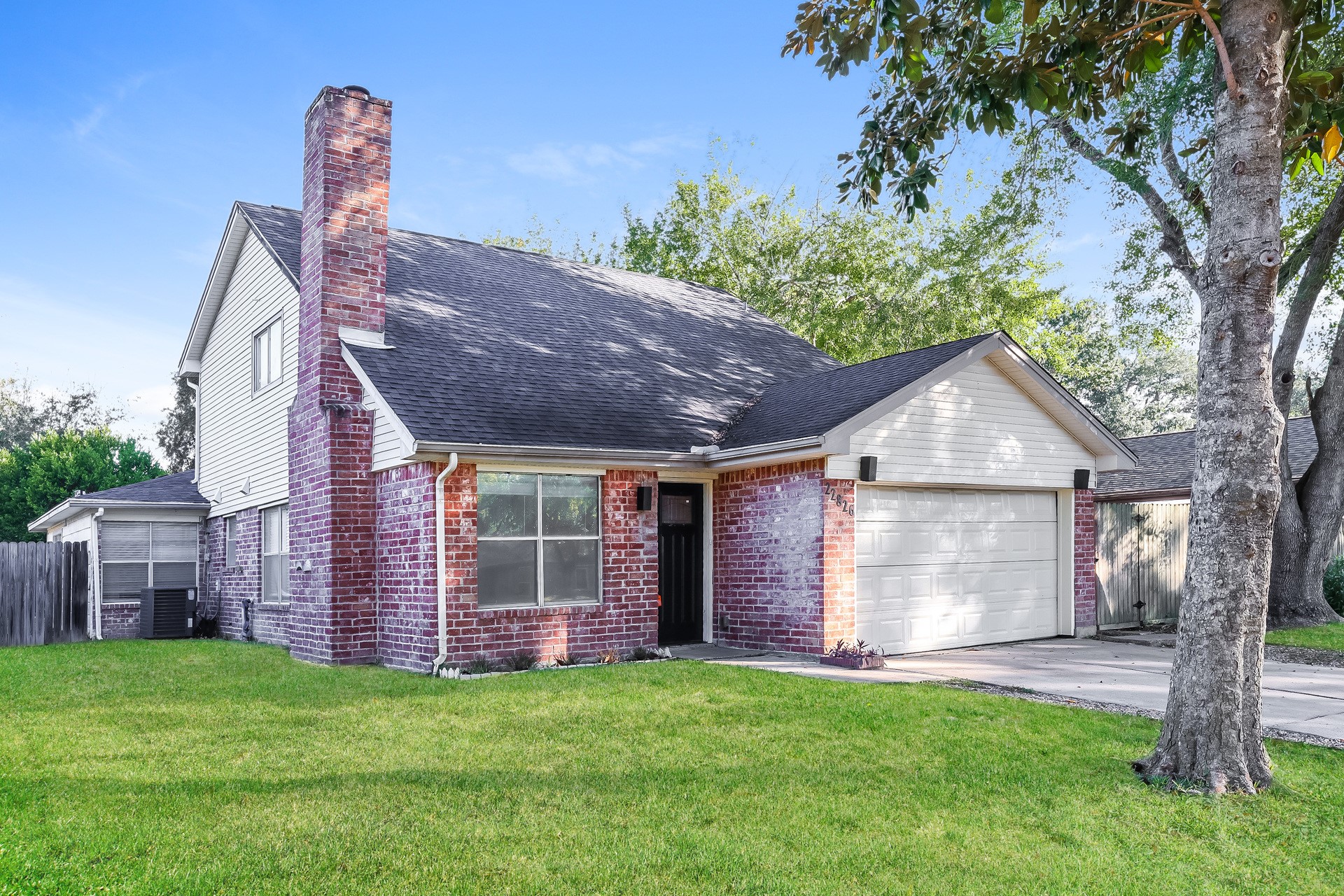 22826 Provincial Boulevard Katy, TX 77450 - Photo 2 of 18 a front view of a house with garden