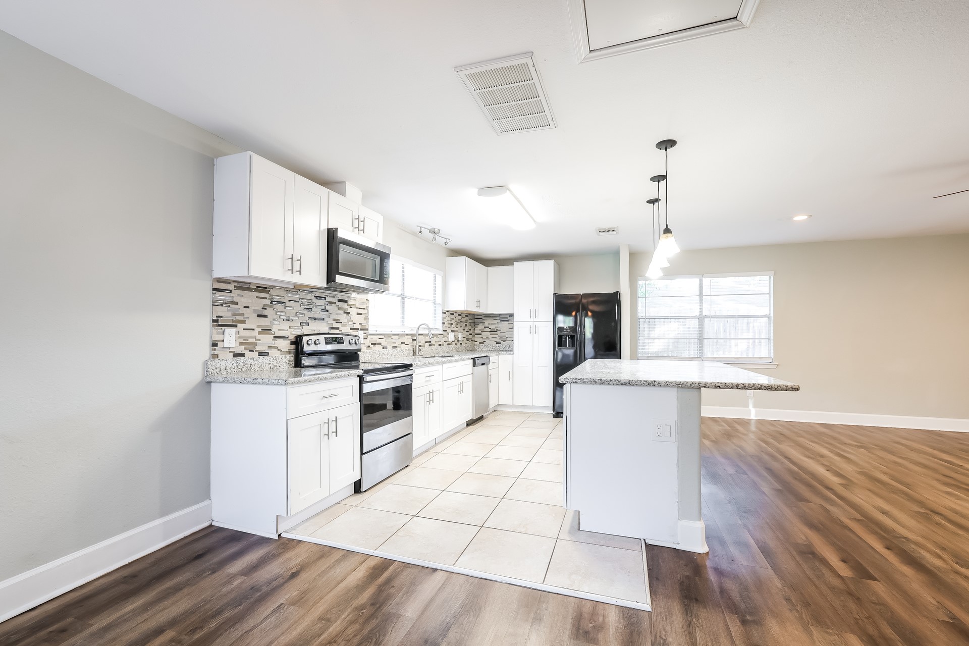 22826 Provincial Boulevard Katy, TX 77450 - Photo 6 of 18 a kitchen with white cabinets and white appliances