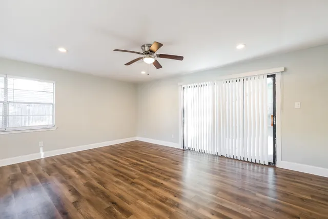 wooden floor in an empty room with a window